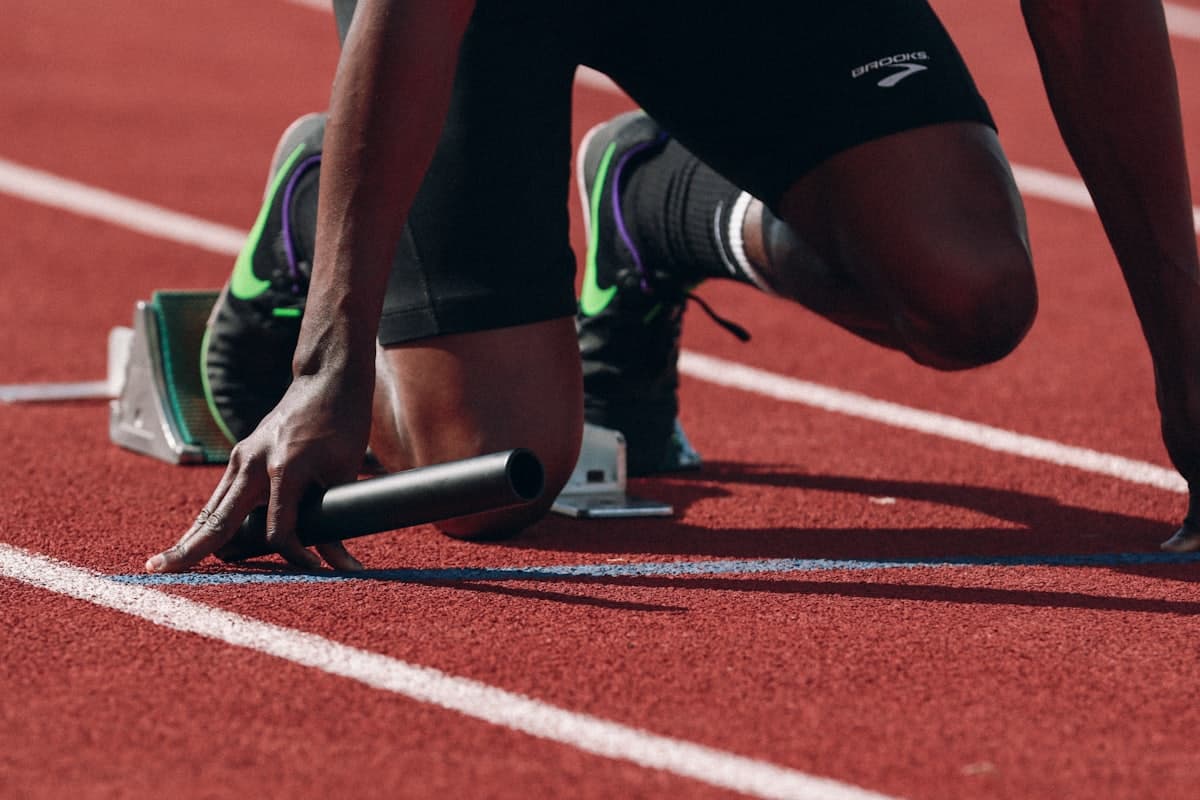 A runner ready to launch from the starting blocks